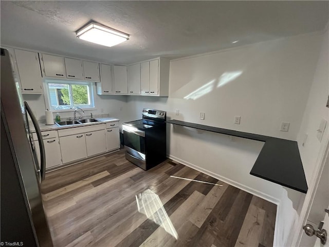 kitchen with dark wood-type flooring, sink, a textured ceiling, appliances with stainless steel finishes, and white cabinetry