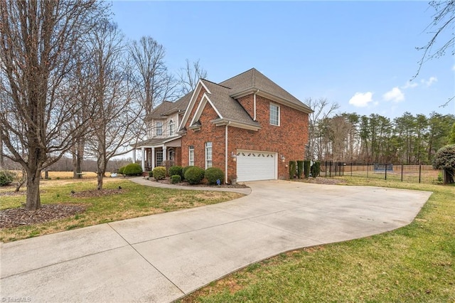 view of side of property featuring brick siding, concrete driveway, a yard, and fence