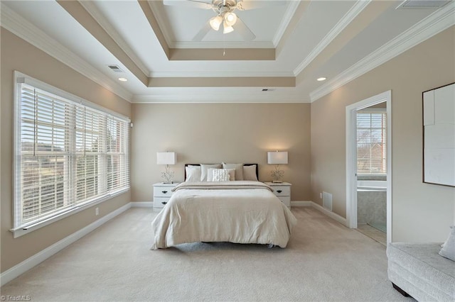 bedroom with visible vents, baseboards, a tray ceiling, ornamental molding, and light carpet