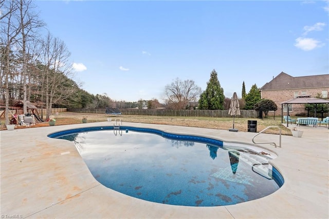 view of swimming pool featuring a fenced in pool, a fenced backyard, and a patio area