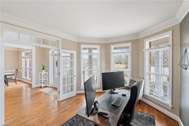 office space featuring light wood-style flooring, french doors, and ornamental molding