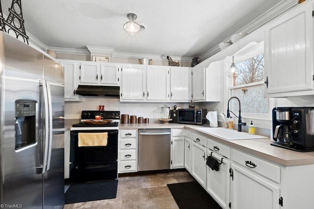 kitchen featuring appliances with stainless steel finishes, white cabinetry, sink, hanging light fixtures, and ornamental molding