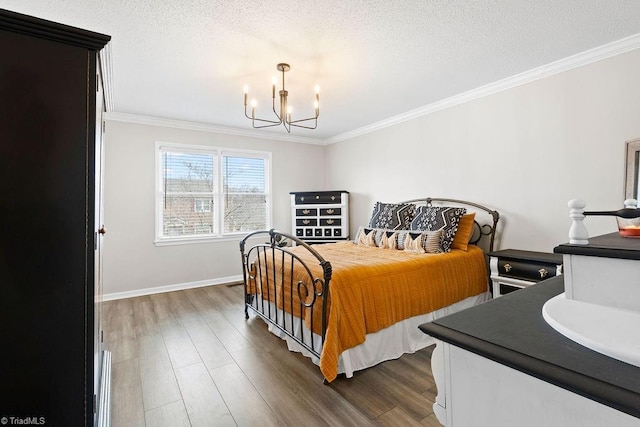 bedroom with a textured ceiling, a chandelier, ornamental molding, and dark hardwood / wood-style floors