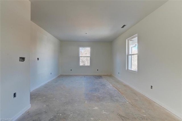 unfurnished room featuring visible vents and baseboards