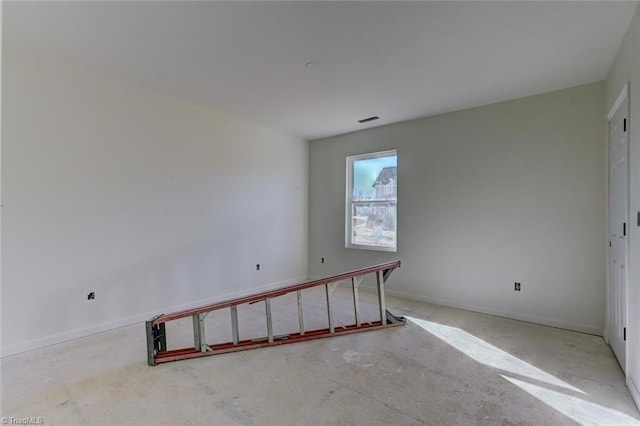 empty room featuring visible vents and baseboards