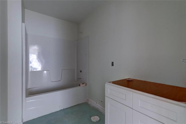 full bath featuring shower / bathing tub combination and concrete flooring