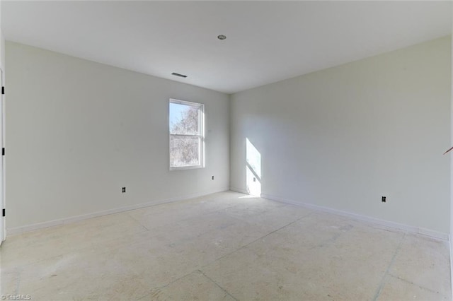 empty room featuring visible vents and baseboards