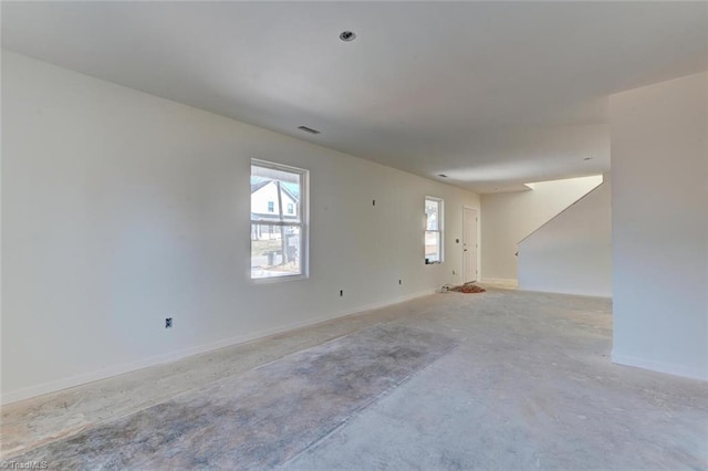 empty room featuring visible vents and baseboards