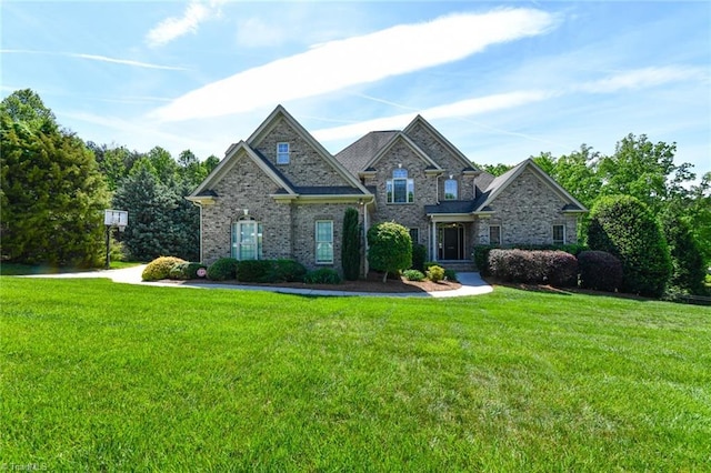view of front facade featuring brick siding and a front yard
