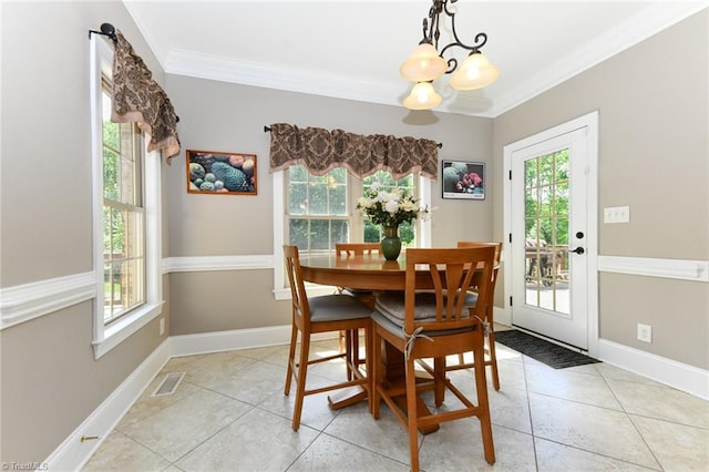 dining room with visible vents, ornamental molding, light tile patterned flooring, and a chandelier