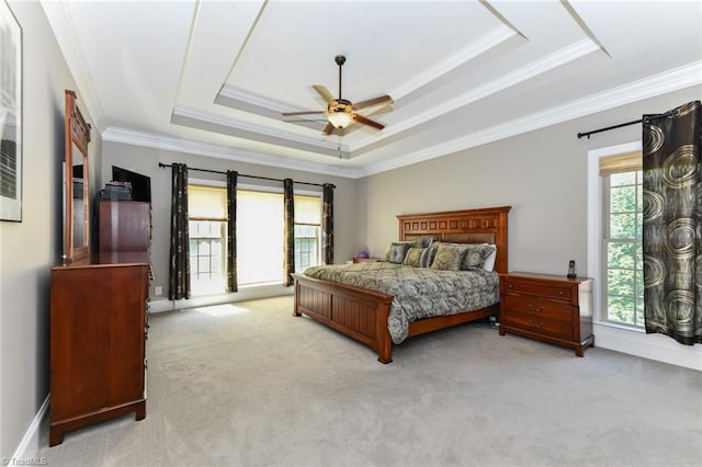 bedroom featuring carpet floors, ornamental molding, and a tray ceiling