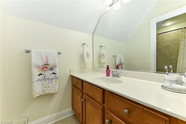 bathroom featuring baseboards, tile patterned flooring, and vanity