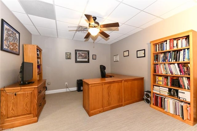 office space with ceiling fan, light carpet, and a drop ceiling