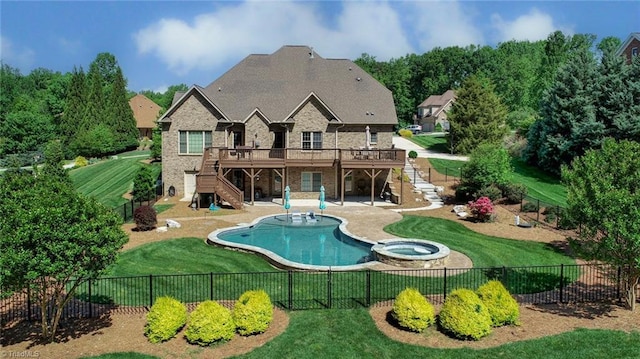 rear view of house with a wooden deck, stairs, a yard, and a fenced backyard