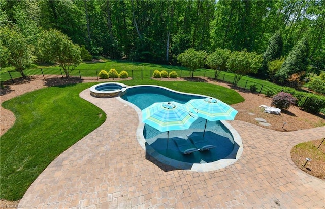 view of swimming pool with a yard, a patio, a pool with connected hot tub, and a fenced backyard