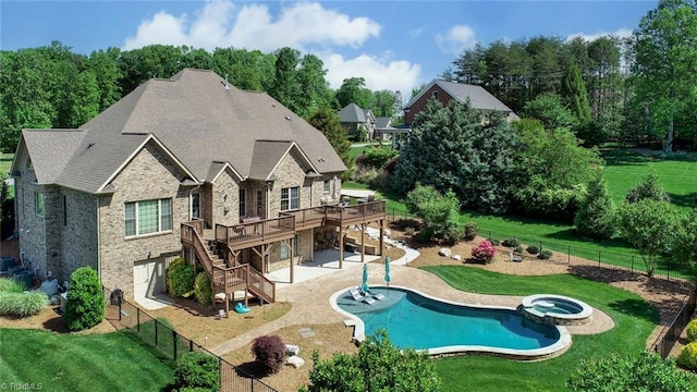 back of house with a fenced backyard, a wooden deck, a yard, and stairway