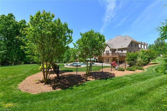 view of yard with a fenced in pool, fence, and a deck