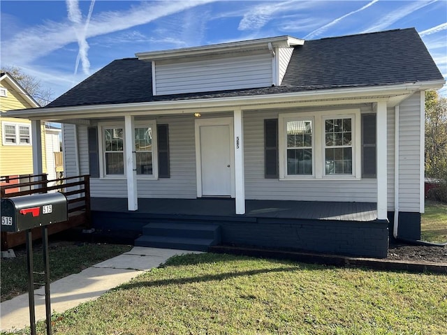 view of front of house with covered porch and a front yard