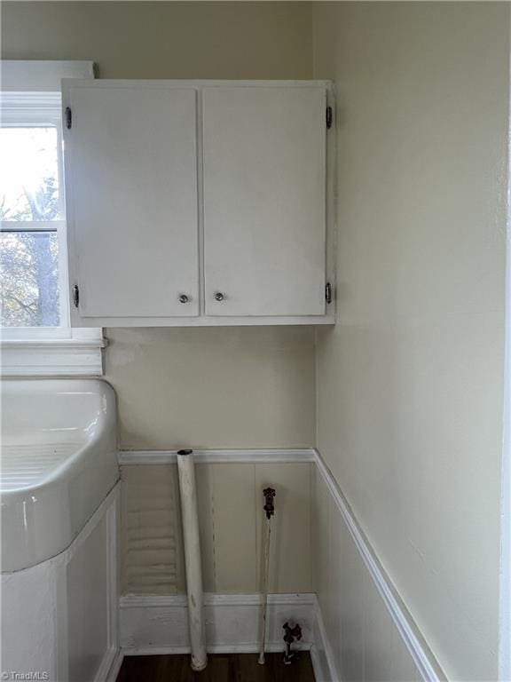 laundry area with cabinets