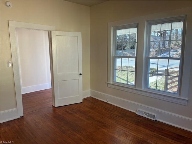 empty room with dark hardwood / wood-style floors