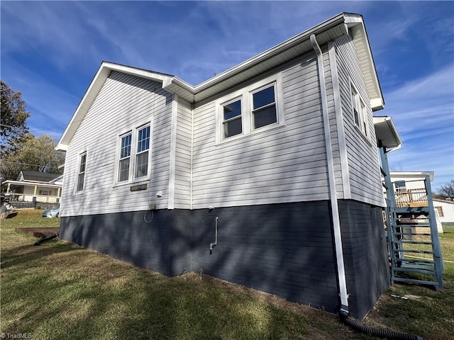 view of property exterior with a yard