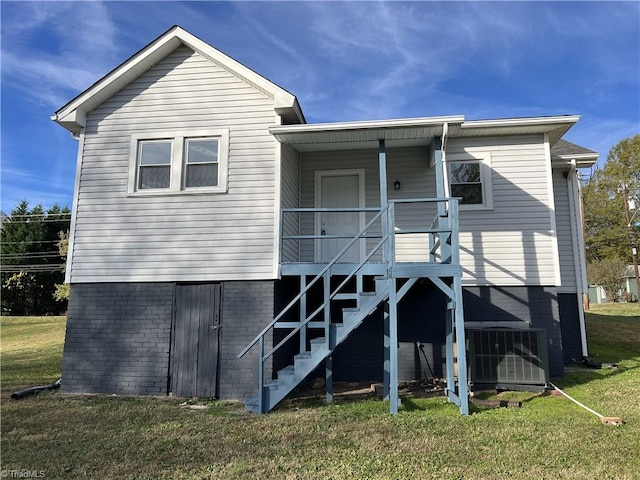 rear view of property with a yard