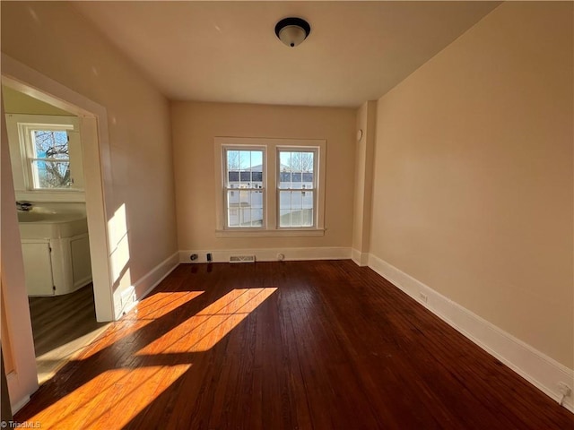 spare room featuring dark hardwood / wood-style flooring