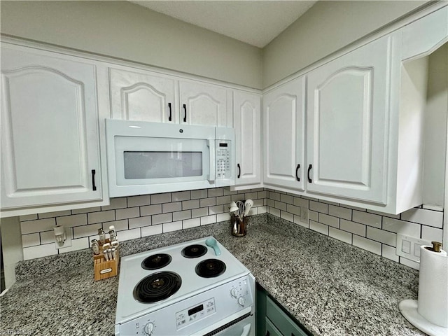 kitchen featuring white cabinets, white appliances, dark stone counters, and backsplash