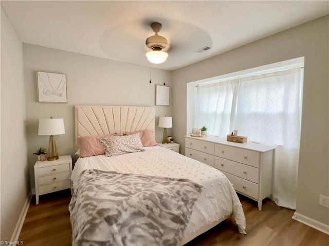 bedroom featuring hardwood / wood-style floors and ceiling fan