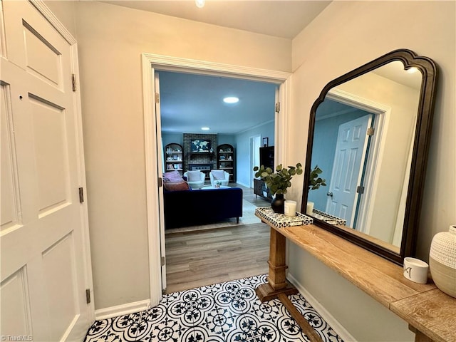 corridor with light hardwood / wood-style floors