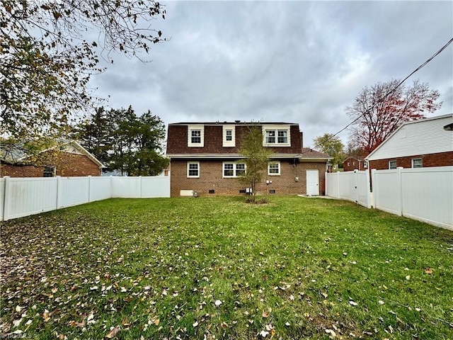 rear view of house featuring a yard