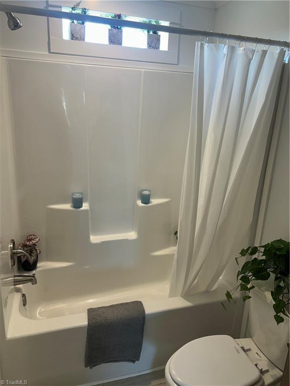 3700 Ireland Rd, Yadkinville, NC 27011 - full bath featuring shower / tub combo with curtain and toilet