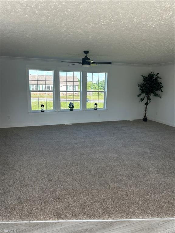 3700 Ireland Rd, Yadkinville, NC 27011 - empty room with ceiling fan, a textured ceiling, healthy amount of natural light, crown molding, and carpet