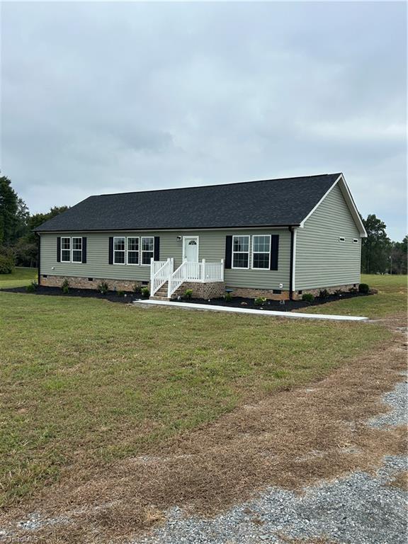 3700 Ireland Rd, Yadkinville, NC 27011 - view of front of house with crawl space, a front lawn, and a shingled roof