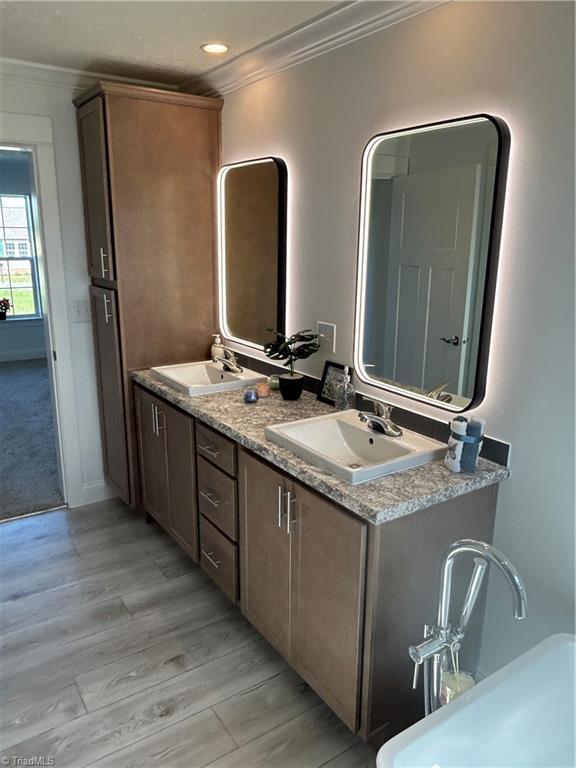 3700 Ireland Rd, Yadkinville, NC 27011 - full bath featuring crown molding, wood finished floors, double vanity, and recessed lighting