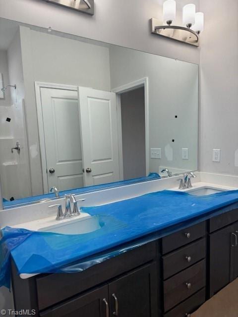 bathroom featuring vanity and a chandelier