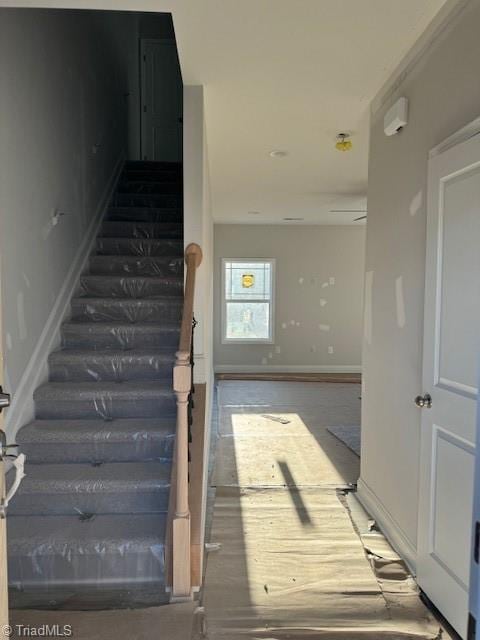 staircase with hardwood / wood-style floors