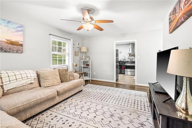 1126 E Springfield Rd, High Point, NC 27263 - living room with a ceiling fan, wood finished floors, and baseboards