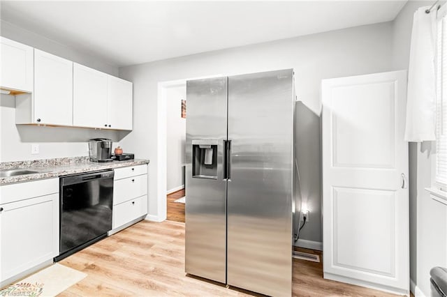 1126 E Springfield Rd, High Point, NC 27263 - kitchen featuring stainless steel fridge with ice dispenser, black dishwasher, white cabinets, light wood-style flooring, and baseboards