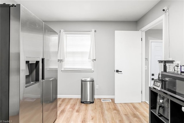 1126 E Springfield Rd, High Point, NC 27263 - kitchen with light wood-style floors, stainless steel fridge with ice dispenser, and baseboards