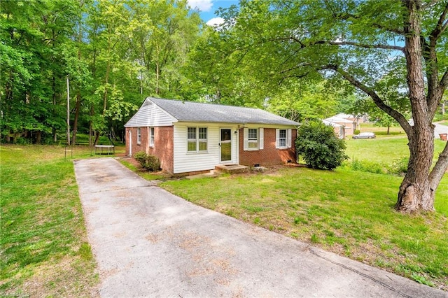 1126 E Springfield Rd, High Point, NC 27263 - view of front of house featuring driveway, brick siding, and a front lawn