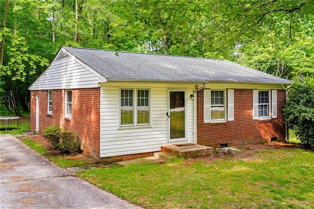 1126 E Springfield Rd, High Point, NC 27263 - view of front of home featuring a trampoline, roof with shingles, a front yard, and crawl space