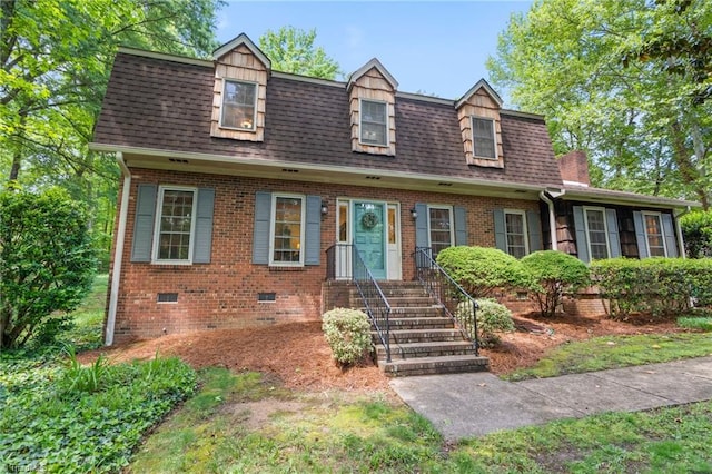 view of front facade featuring crawl space, roof with shingles, and brick siding