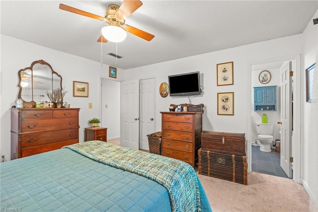 carpeted bedroom with connected bathroom, a closet, a ceiling fan, and baseboards