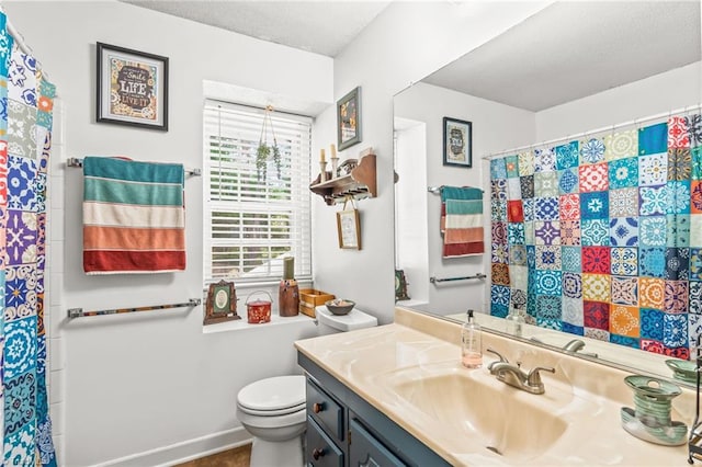 bathroom with toilet, vanity, a shower with shower curtain, and a textured ceiling