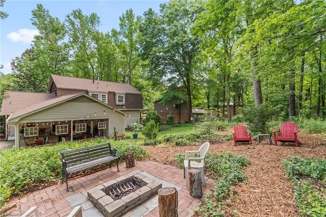 view of yard with an outdoor fire pit and a patio area