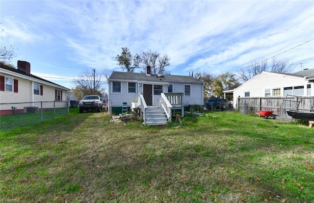 back of house with a lawn