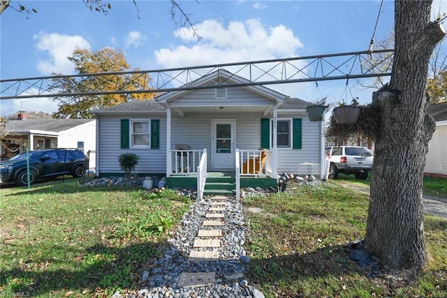 bungalow-style home with a porch and a front yard