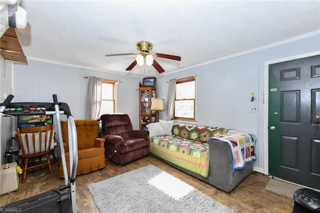 living room featuring ornamental molding, hardwood / wood-style floors, and ceiling fan