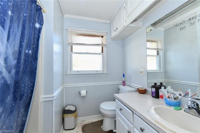 bathroom with ornamental molding, toilet, and vanity